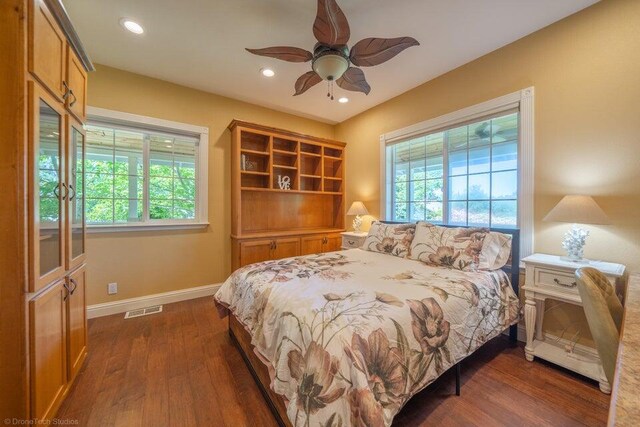 bedroom featuring ceiling fan and dark hardwood / wood-style flooring