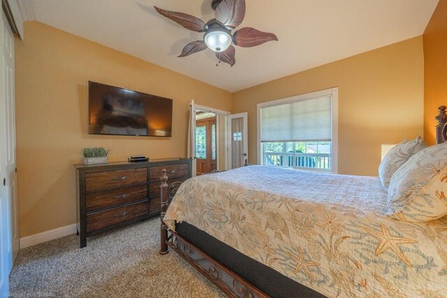 bedroom featuring carpet, vaulted ceiling, and ceiling fan