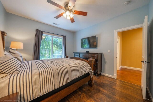 bedroom with ceiling fan and dark wood-type flooring