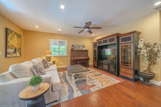 living room with hardwood / wood-style floors and ceiling fan