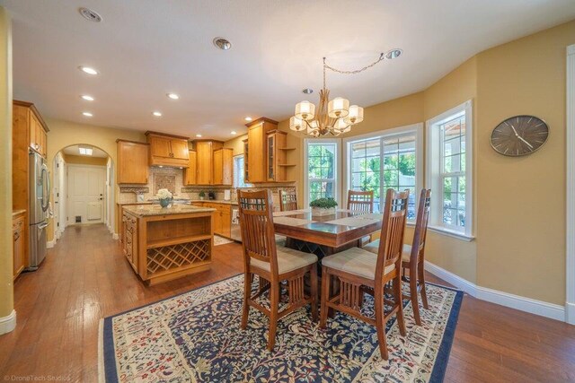 dining area featuring light wood-type flooring and an inviting chandelier