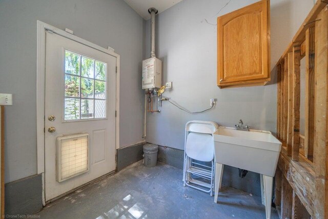 laundry area with tankless water heater