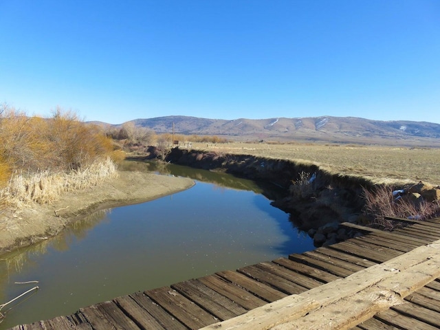 exterior space featuring a water and mountain view