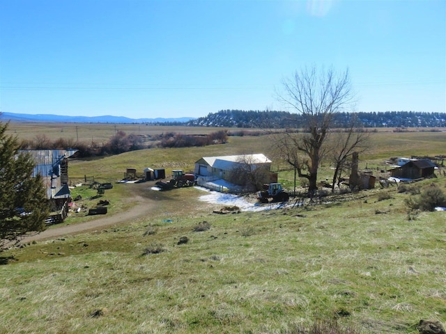 birds eye view of property featuring a mountain view and a rural view