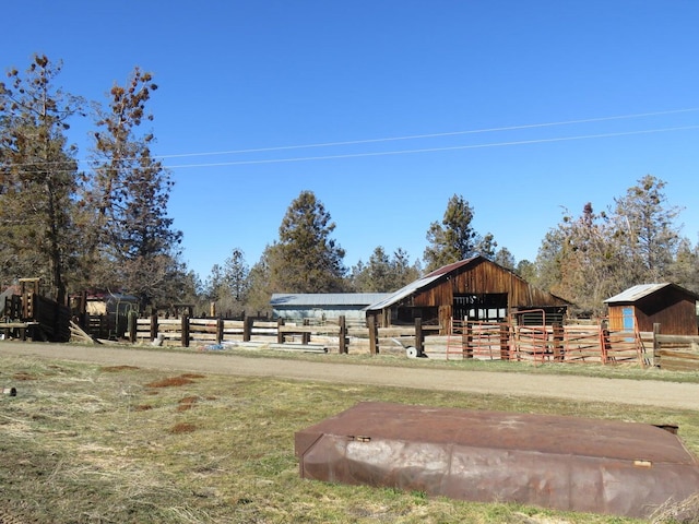 view of yard featuring a rural view and an outdoor structure