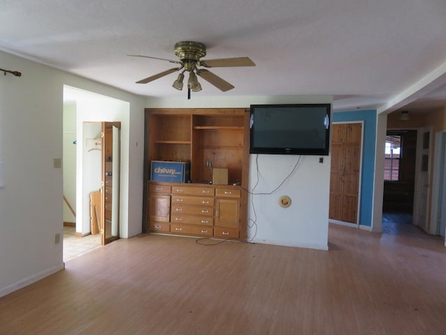 unfurnished living room featuring wood-type flooring, a textured ceiling, and ceiling fan