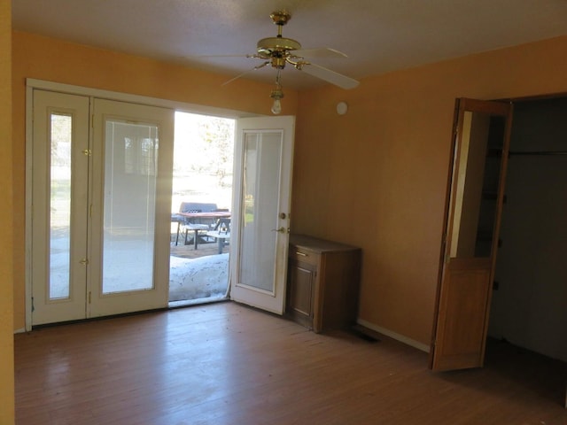 doorway to outside featuring ceiling fan, french doors, and light wood-type flooring