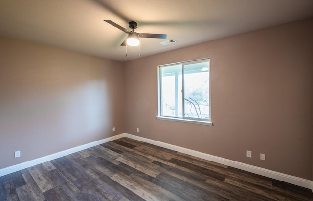 empty room with ceiling fan and dark wood-type flooring