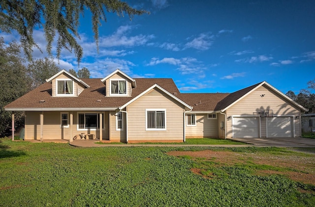 view of front of house with a porch, a garage, and a front lawn