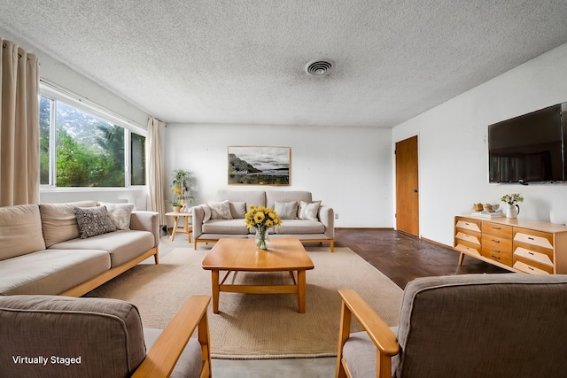 living room with hardwood / wood-style flooring and a textured ceiling