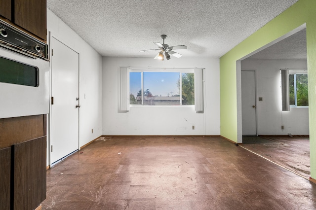 interior space featuring ceiling fan and a textured ceiling