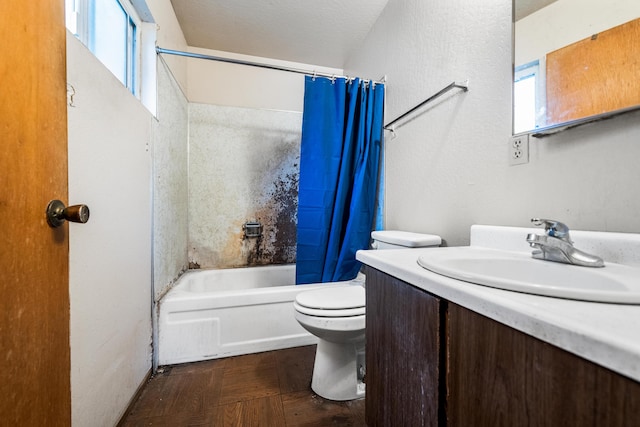 full bathroom with shower / bath combo with shower curtain, plenty of natural light, vanity, and a textured ceiling