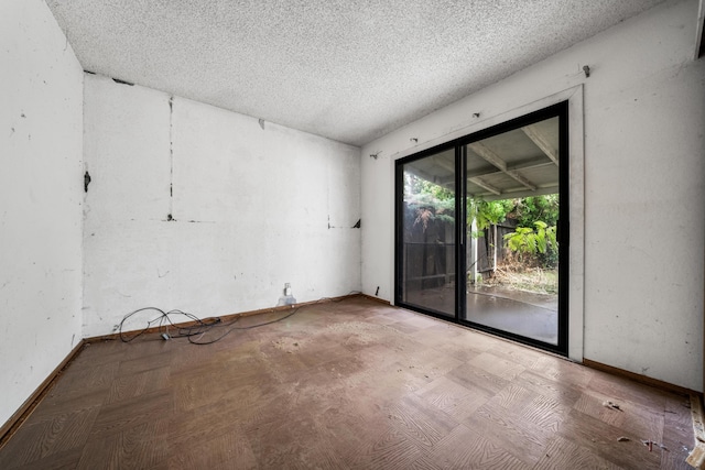 empty room featuring a textured ceiling