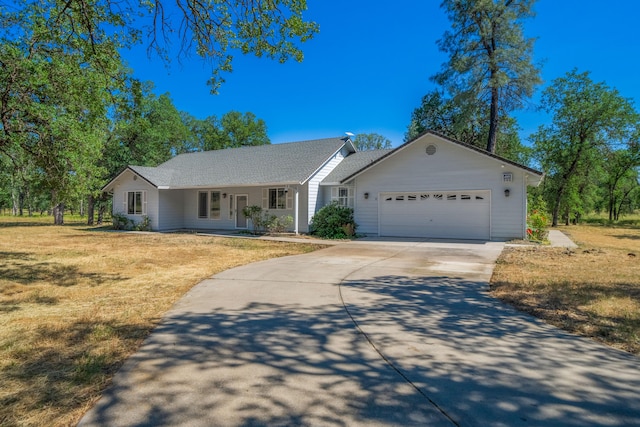 single story home with a front yard and a garage