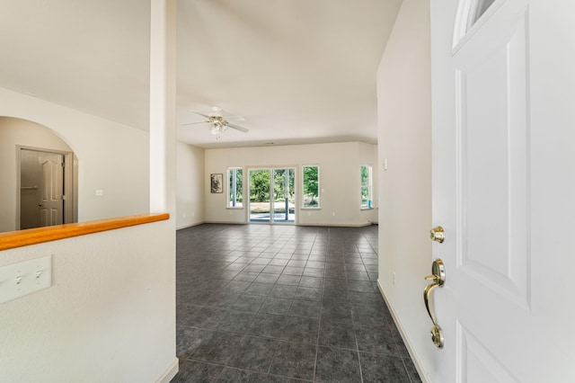 interior space featuring ceiling fan and dark tile patterned floors