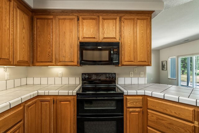 kitchen featuring black appliances and tile counters