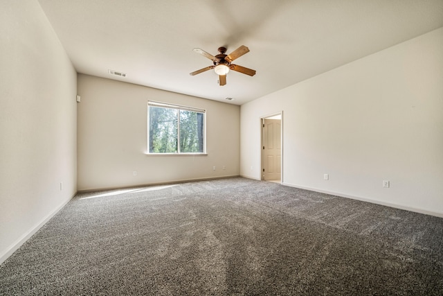 empty room featuring ceiling fan and carpet