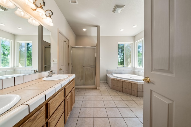 bathroom with tile patterned floors, a wealth of natural light, and plus walk in shower