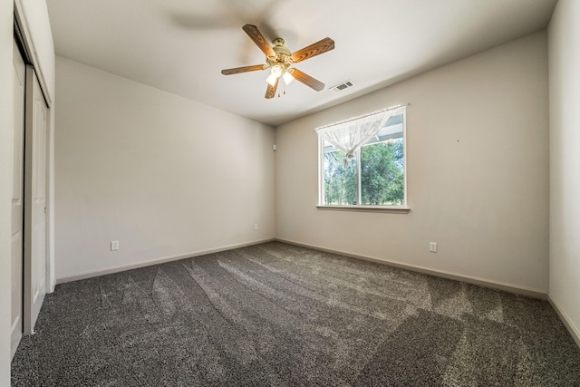 carpeted empty room featuring ceiling fan