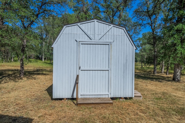 view of outbuilding featuring a lawn