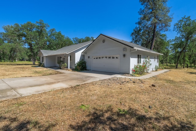 ranch-style home featuring a garage and a front lawn