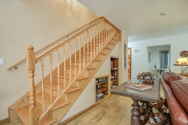 stairs with hardwood / wood-style flooring