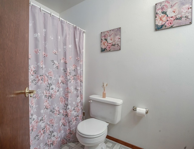 bathroom with tile patterned flooring, toilet, and curtained shower