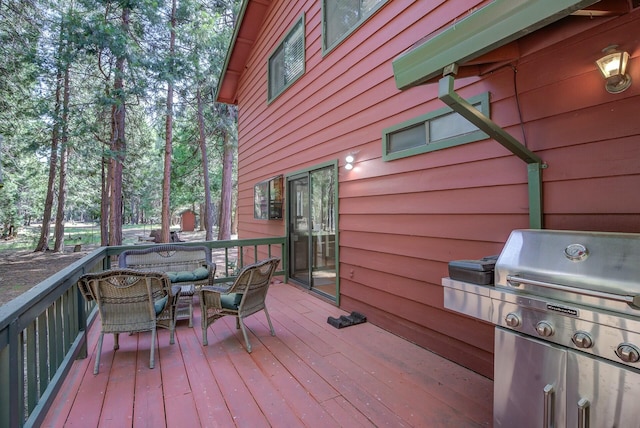 wooden terrace featuring grilling area