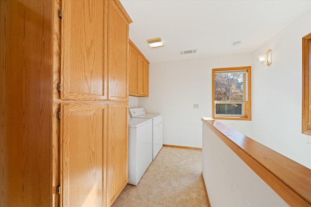 laundry area with cabinets and independent washer and dryer