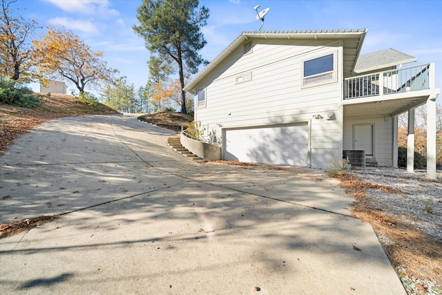 exterior space featuring a garage and a balcony