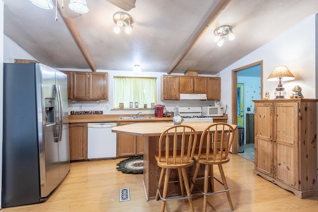 kitchen featuring vaulted ceiling with beams, white appliances, light hardwood / wood-style floors, and sink