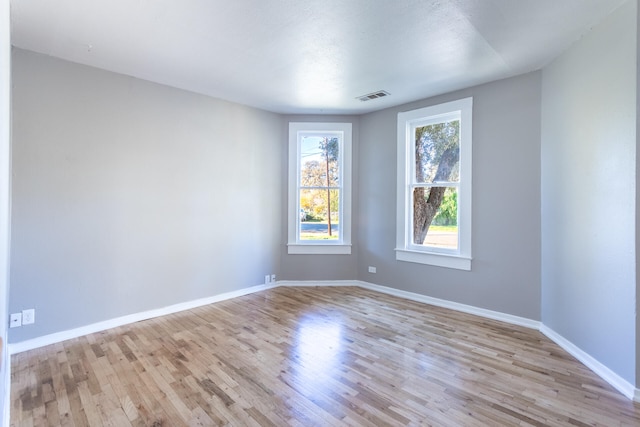 unfurnished room with light hardwood / wood-style flooring