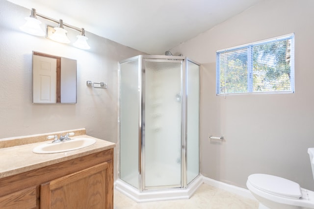 bathroom with tile patterned flooring, vanity, toilet, and walk in shower