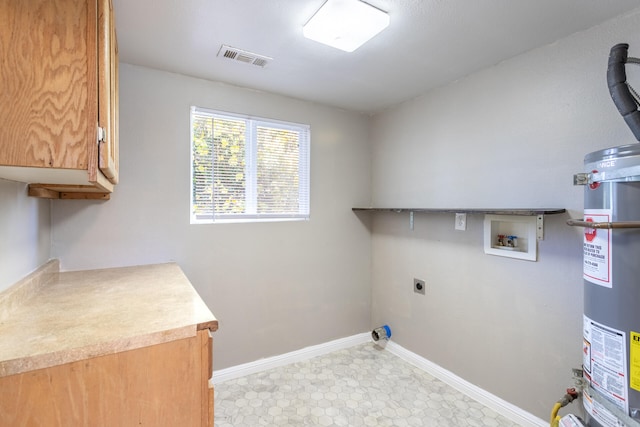 clothes washing area featuring hookup for an electric dryer, hookup for a washing machine, cabinets, and strapped water heater