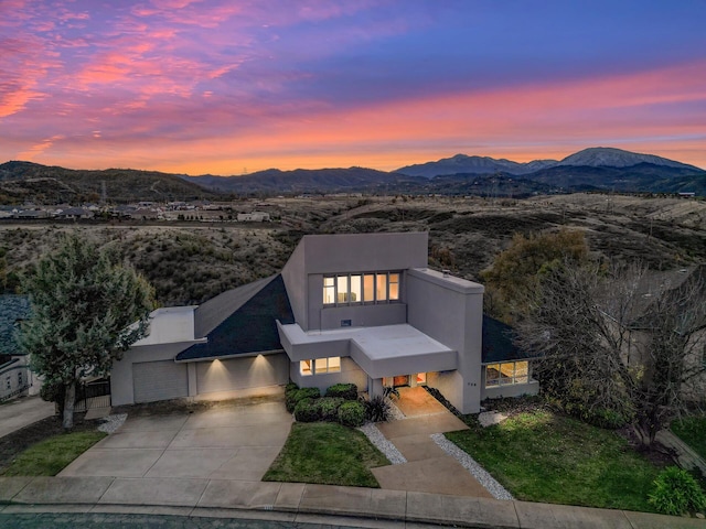 738 Sunriver Ln, Redding, CA 96001 - contemporary home featuring stucco siding, a mountain view, concrete driveway, and a garage