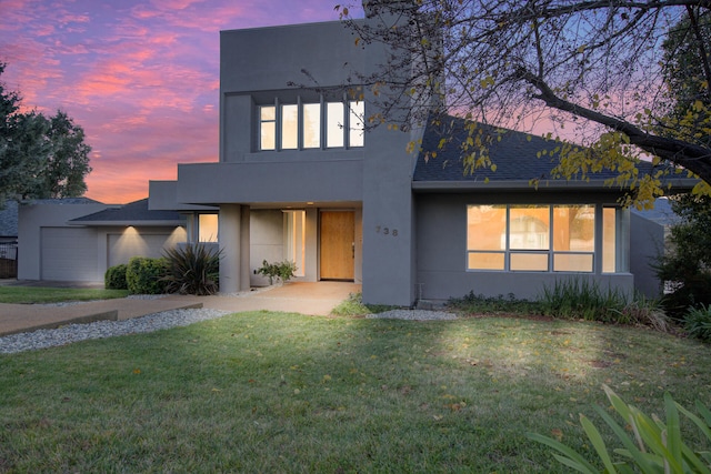 view of front of property with a lawn and a garage