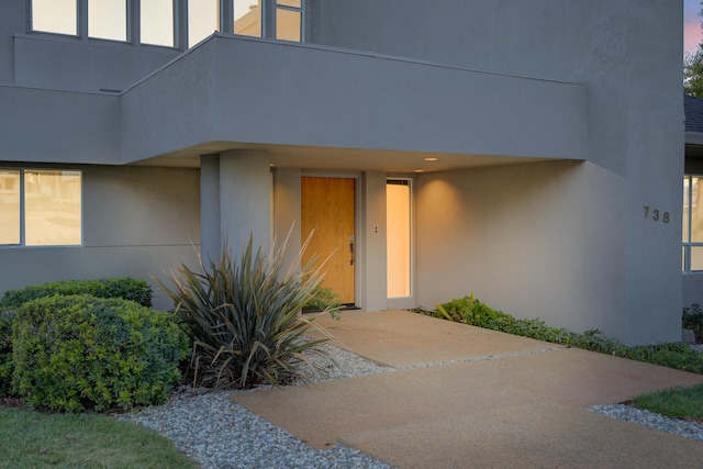 view of exterior entry at dusk