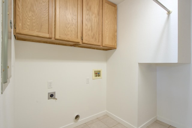 laundry area featuring electric dryer hookup, cabinets, light tile patterned floors, and hookup for a washing machine