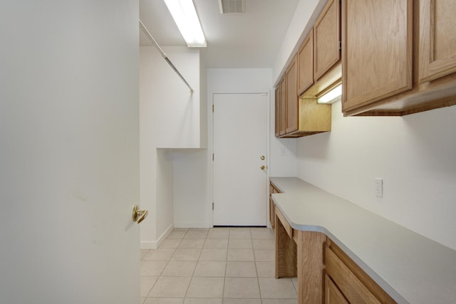 laundry area featuring light tile patterned floors