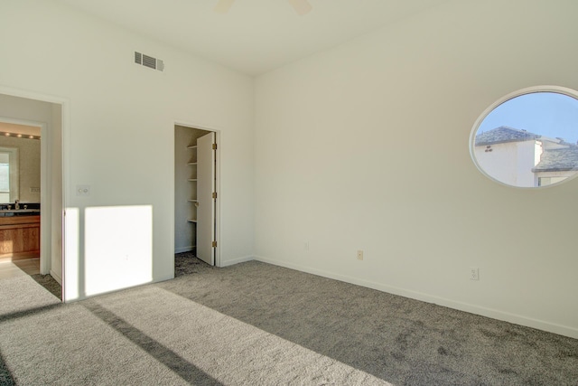 738 Sunriver Ln, Redding, CA 96001 - unfurnished bedroom featuring carpet floors, a walk in closet, a ceiling fan, and ensuite bathroom