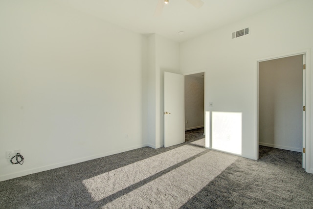 carpeted spare room featuring ceiling fan