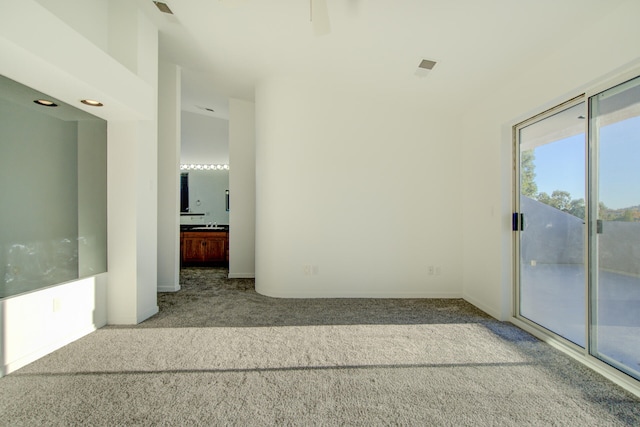 spare room with light colored carpet and ceiling fan