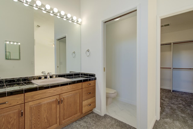 bathroom featuring vanity and toilet