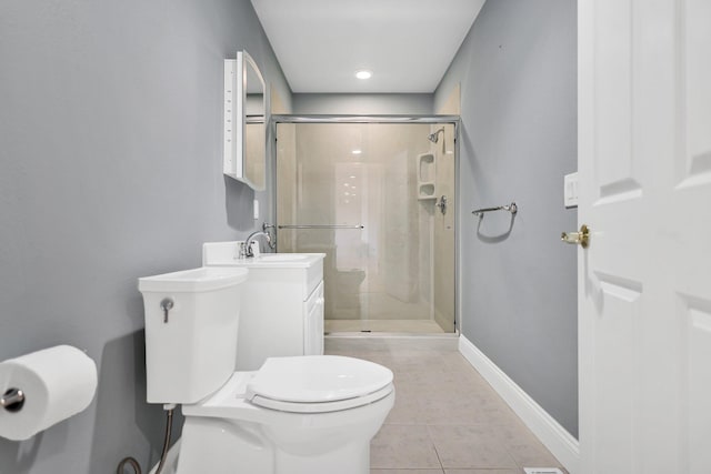 bathroom with tile patterned floors, a shower with door, vanity, and toilet