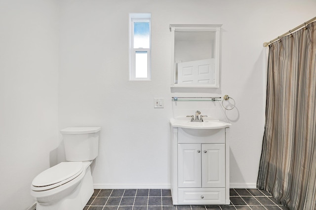 bathroom with tile patterned flooring, vanity, and toilet