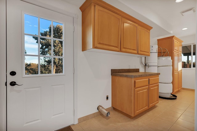 kitchen featuring plenty of natural light and light tile patterned floors