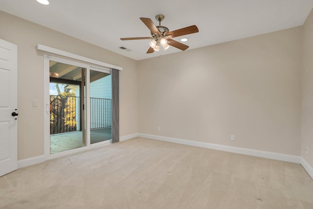 carpeted empty room featuring ceiling fan