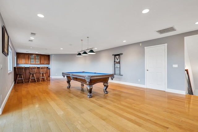 playroom featuring bar, billiards, and light wood-type flooring