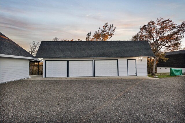 view of garage at dusk