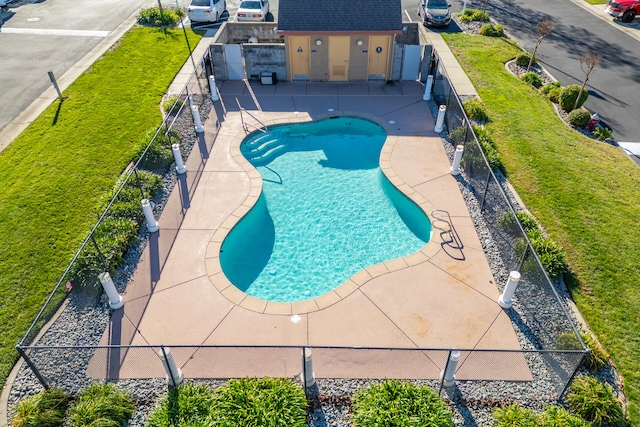 view of pool with a yard, a patio, and an outdoor structure